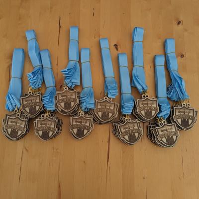 100 finished medals attached to their ribbons